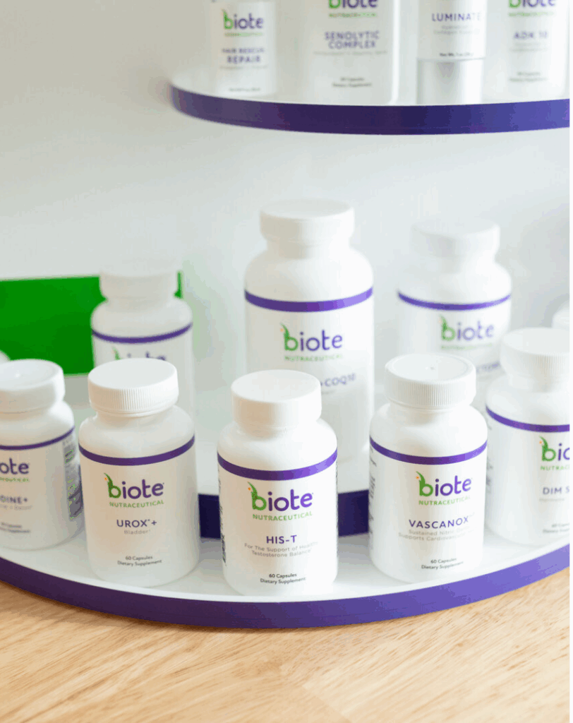 Multiple Biote nutraceutical supplement bottles arranged on a circular shelf