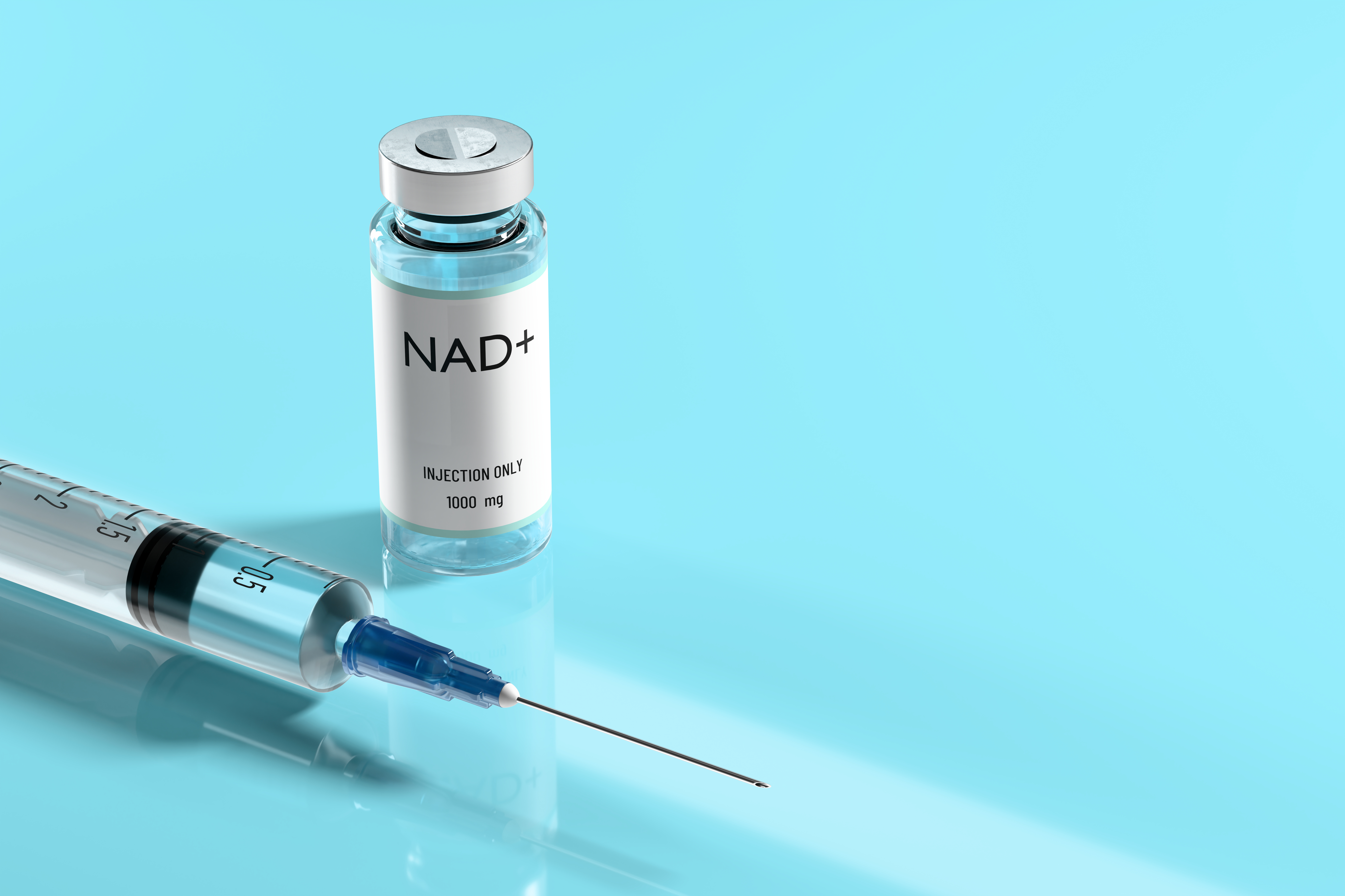 Glass vial labeled NAD+ beside a syringe with needle on a light blue surface